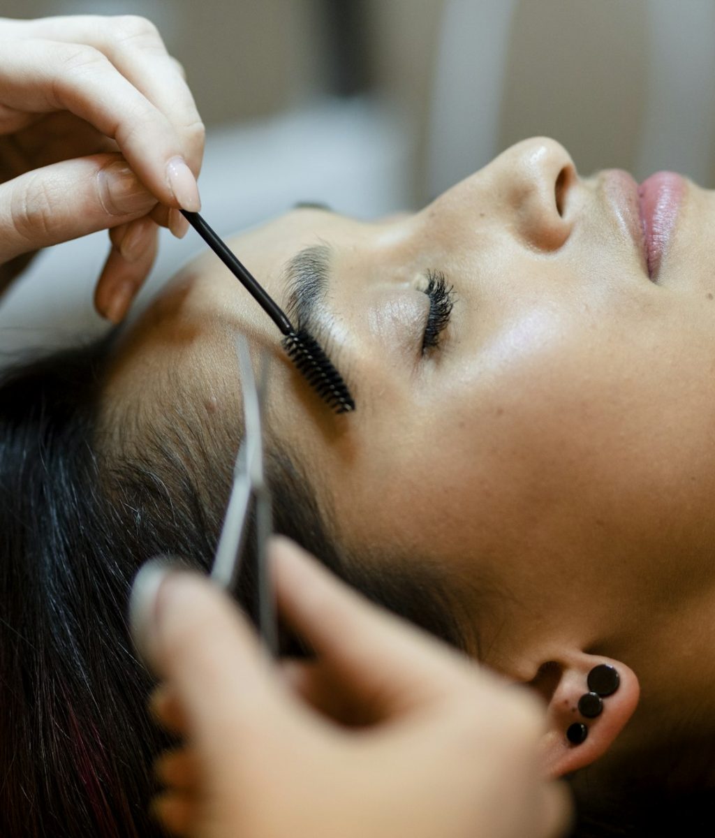 Customer getting eyebrow treatment at a beauty salon